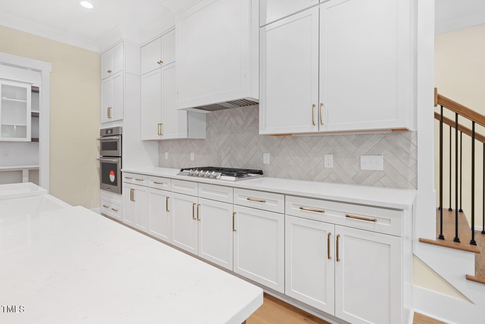 2410 Carpenter Pond Road Raleigh, NC 27613 - Photo 29 of 63 a kitchen with granite countertop white cabinets and white appliances