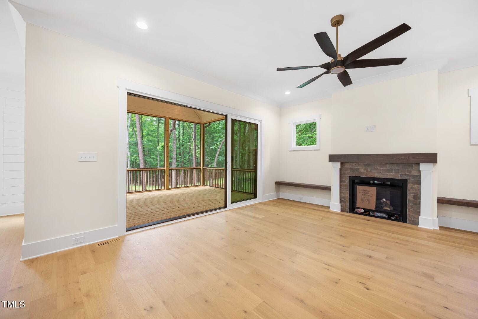 2410 Carpenter Pond Road Raleigh, NC 27613 - Photo 37 of 63 a view of an empty room with a fireplace and a window
