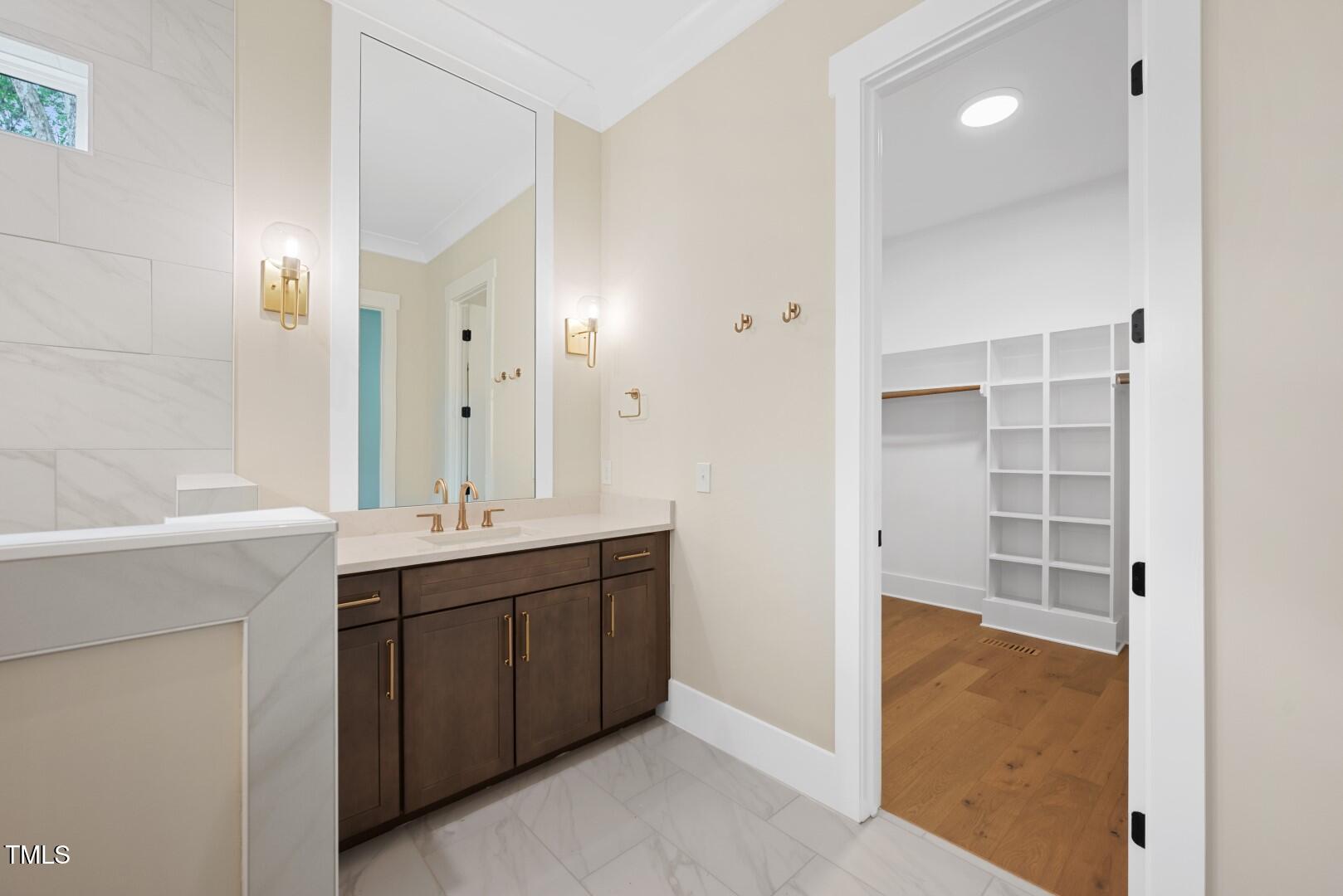 2410 Carpenter Pond Road Raleigh, NC 27613 - Photo 45 of 63 a bathroom with a double vanity sink a mirror and a bathtub