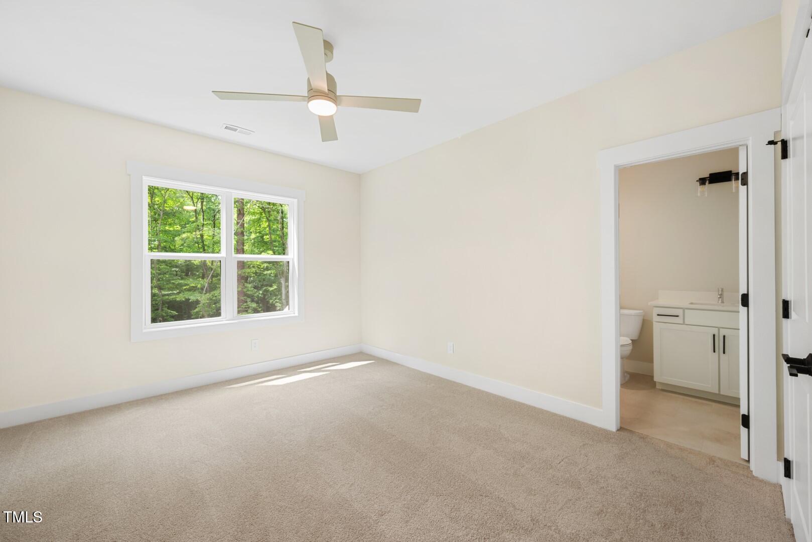 2410 Carpenter Pond Road Raleigh, NC 27613 - Photo 52 of 63 an empty room with a window and a ceiling fan