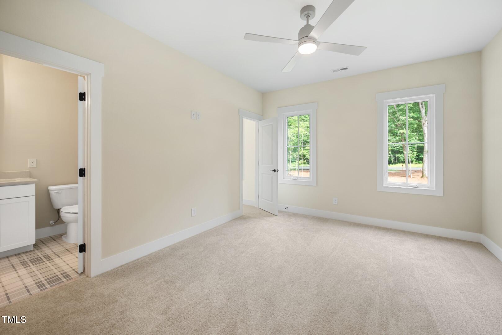 2410 Carpenter Pond Road Raleigh, NC 27613 - Photo 54 of 63 a view of an empty room with a window and a ceiling fan