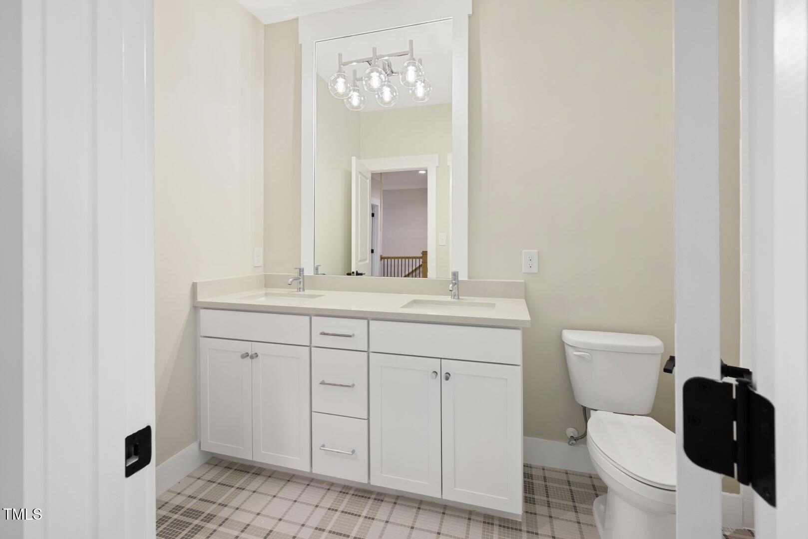 2410 Carpenter Pond Road Raleigh, NC 27613 - Photo 55 of 63 a bathroom with a toilet sink and mirror