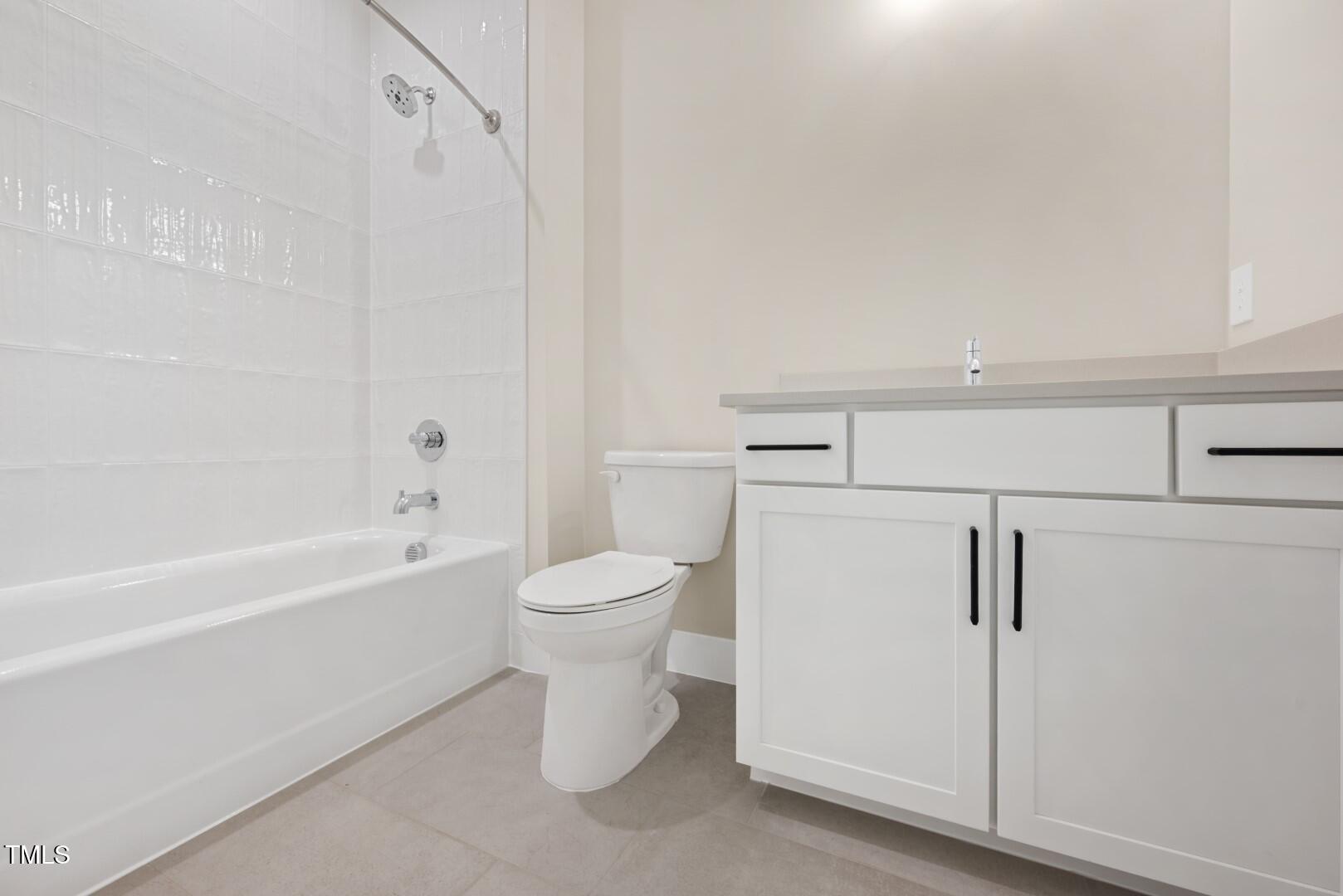 2410 Carpenter Pond Road Raleigh, NC 27613 - Photo 57 of 63 a bathroom with a toilet and a bathtub