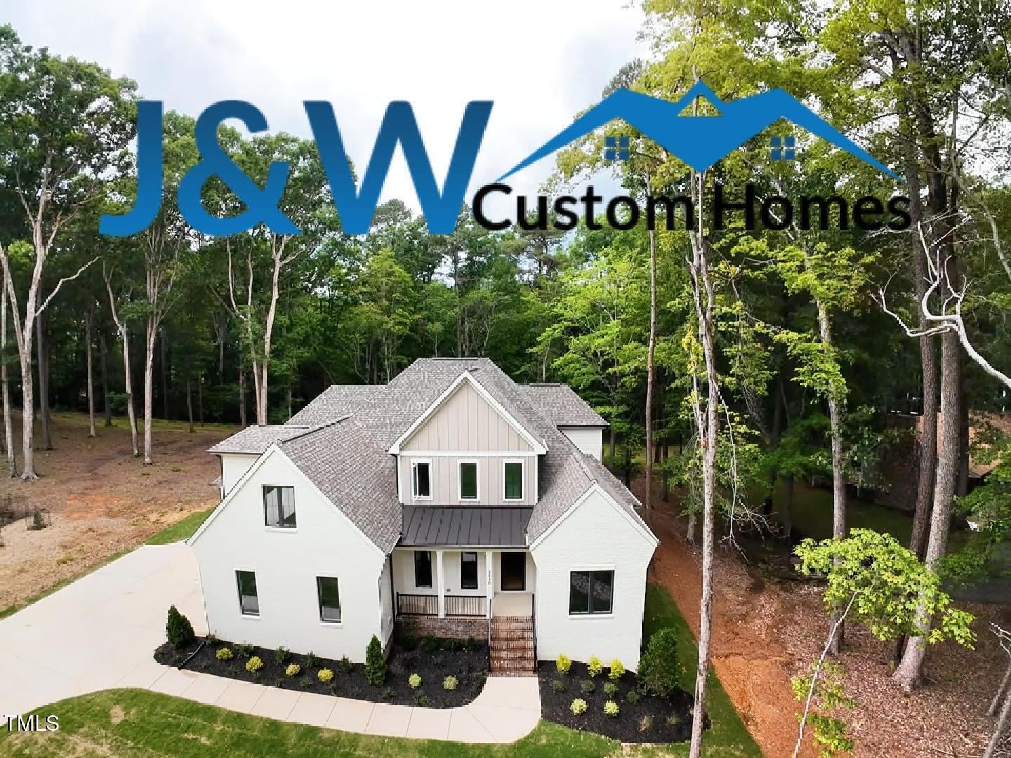 2410 Carpenter Pond Road Raleigh, NC 27613 - Photo 61 of 63 a view of a white house with a yard and potted plants