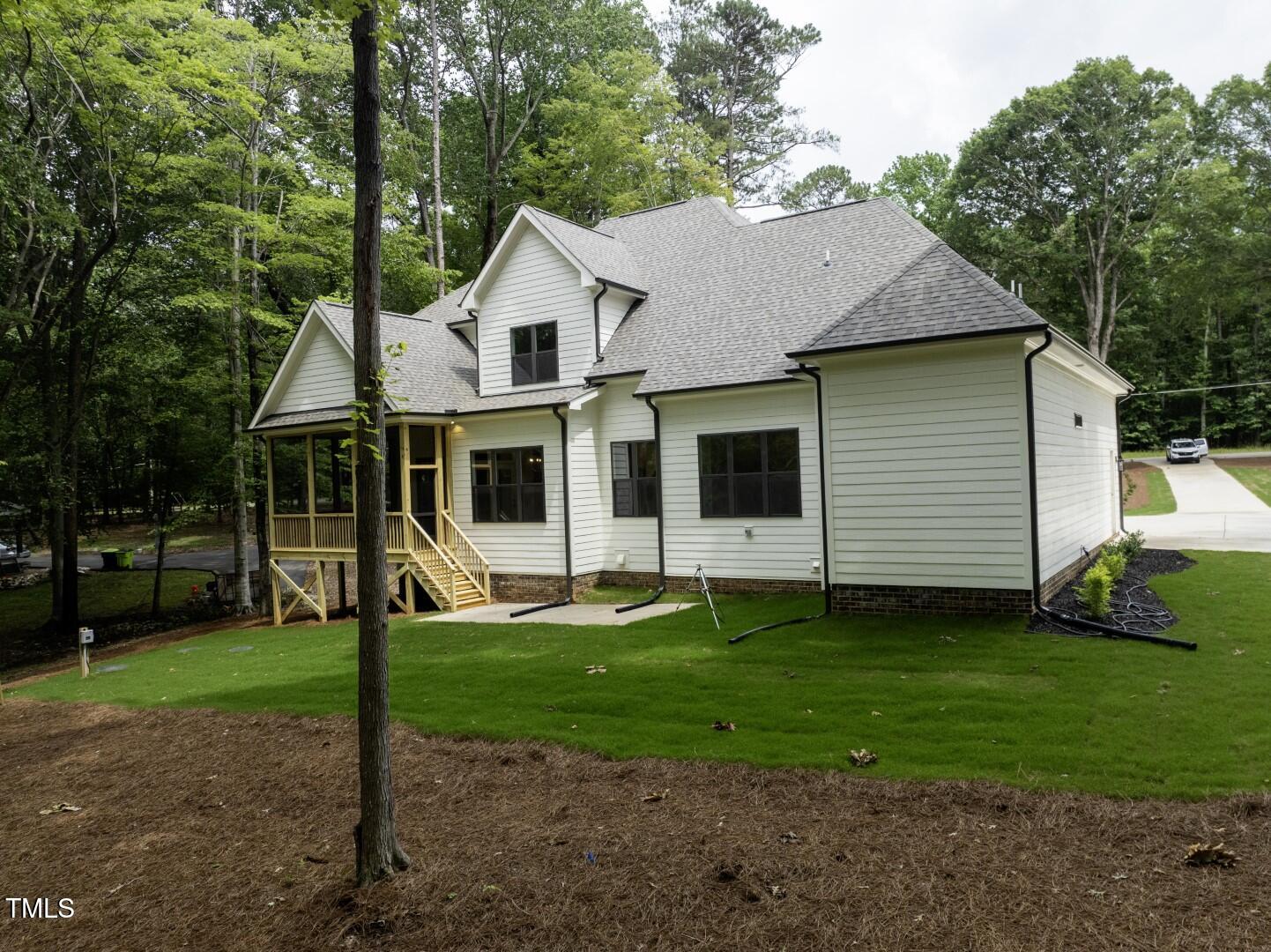 2410 Carpenter Pond Road Raleigh, NC 27613 - Photo 7 of 63 a front view of a house with a yard and trees