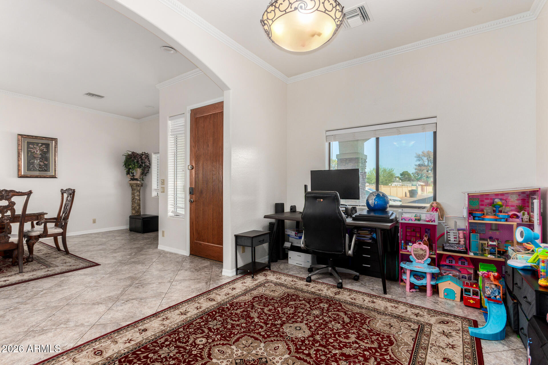 8912 North 15th Lane Phoenix, AZ 85021 - Photo 3 of 17 a view of a livingroom with furniture and a flat screen tv