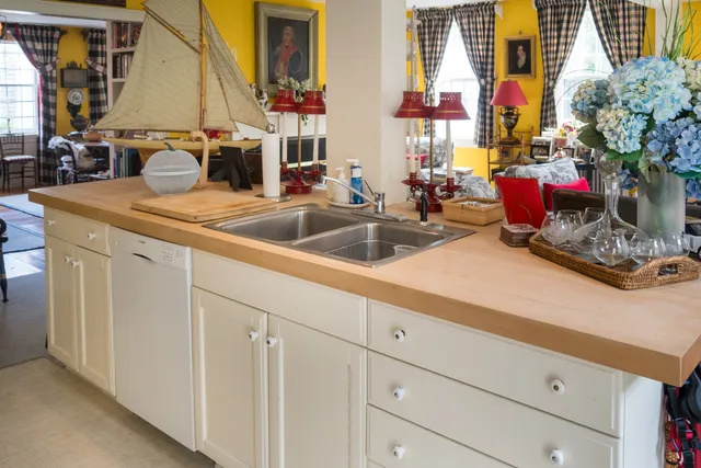 a kitchen with sink and mirror