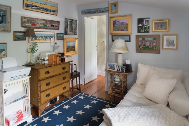 a living room with furniture cabinets and window