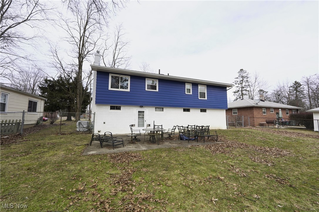 2674 Smith Road Fairlawn, OH 44333 - Photo 5 of 31 Rear view of property featuring a patio area, a fenced backyard, a lawn, and stucco siding