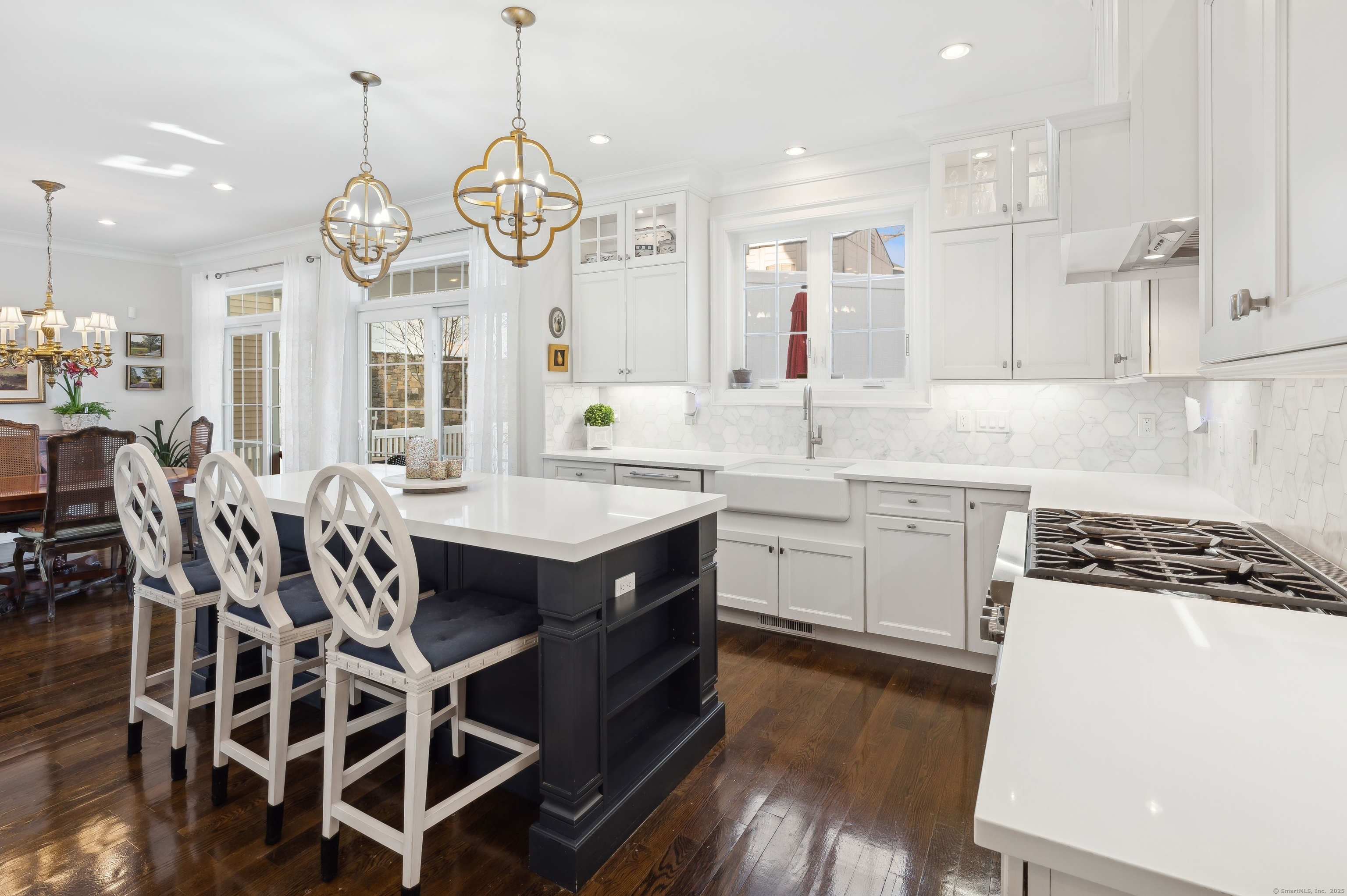 a kitchen with a dining table chairs sink and cabinets