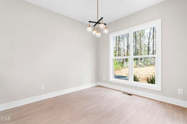 a large kitchen with cabinets a sink and stainless steel appliances