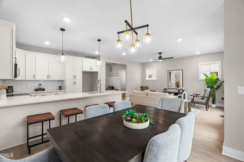 a kitchen with a sink stove and wooden floor