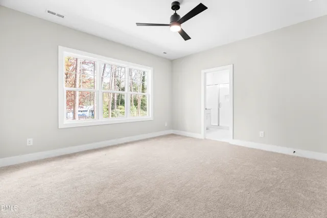 wooden floor fireplace and windows in an empty room
