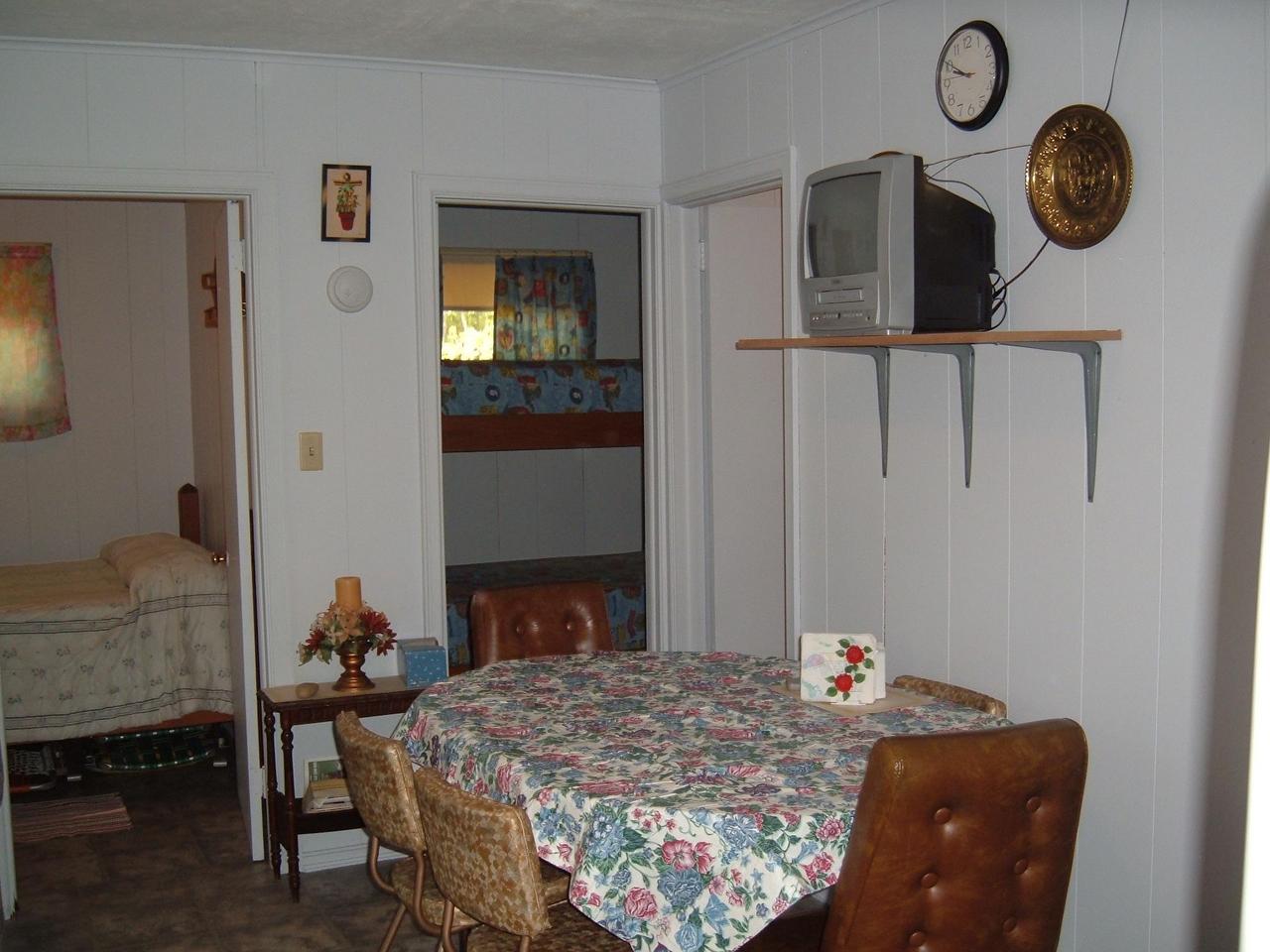 488 Robin Hood Road Kunkletown, PA 18058 - Photo 3 of 6 a bed sitting in a bedroom next to a window with a chandelier