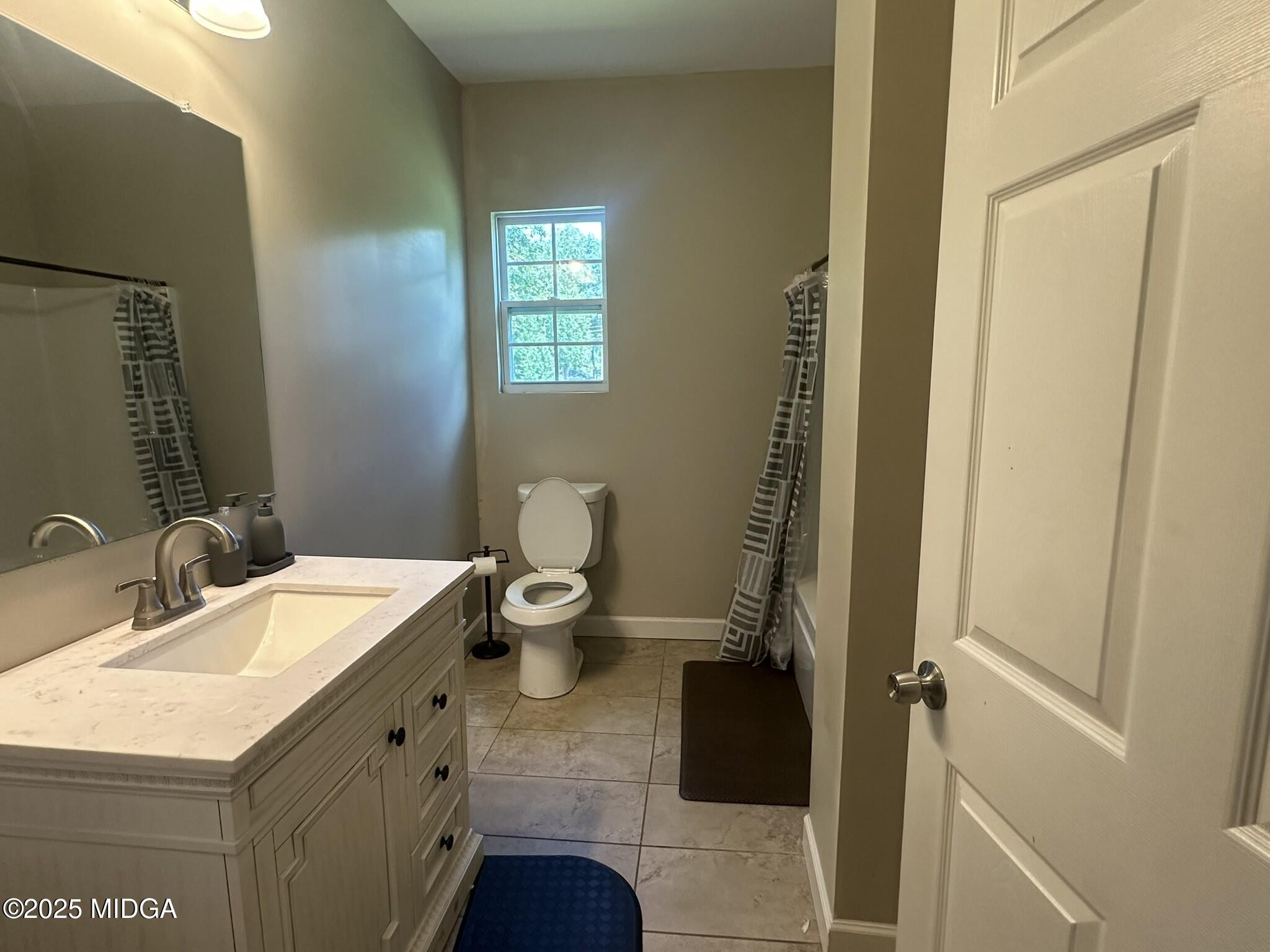 704 Tulip Drive Fort Valley, GA 31030 - Photo 11 of 13 a bathroom with a sink a toilet and shower