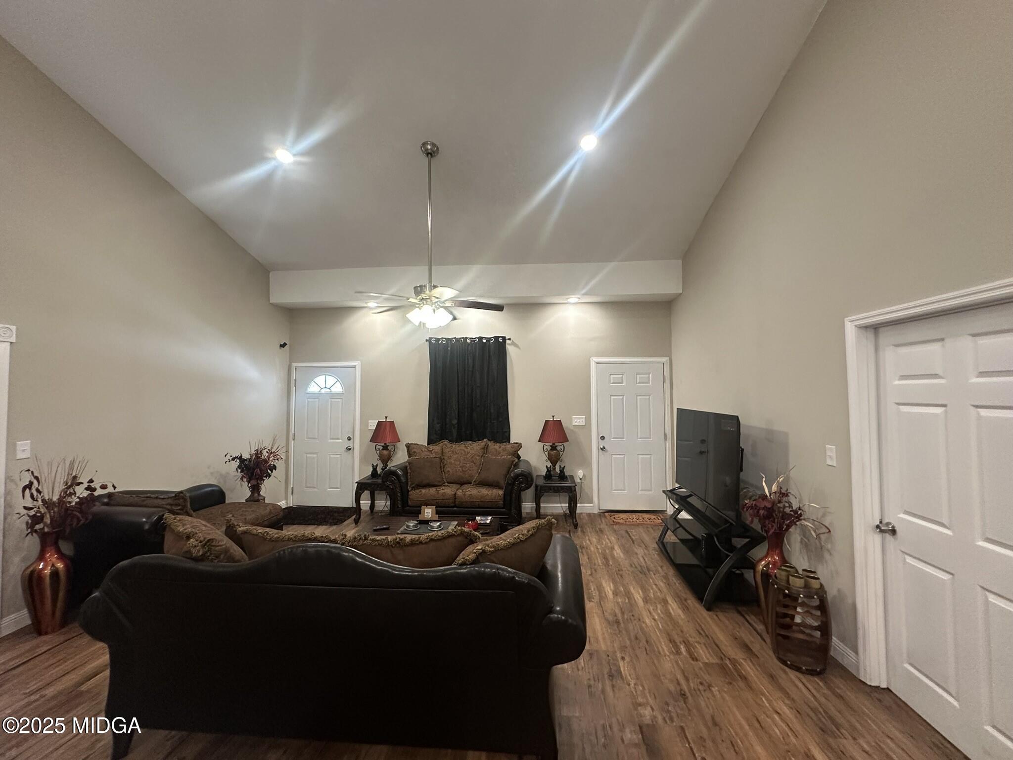 704 Tulip Drive Fort Valley, GA 31030 - Photo 2 of 13 a living room with furniture a chandelier and a flat screen tv
