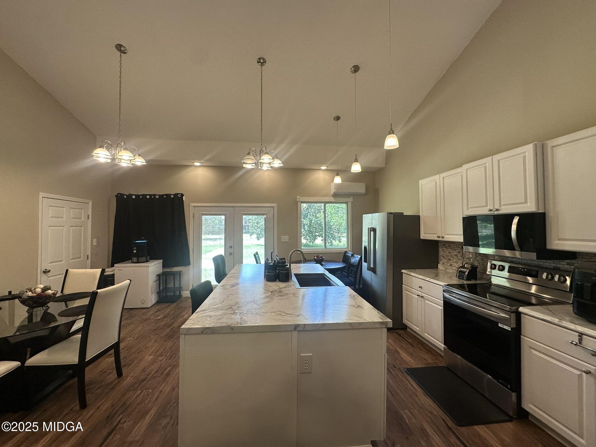 704 Tulip Drive Fort Valley, GA 31030 - Photo 3 of 13 a kitchen with stainless steel appliances granite countertop a sink a stove and a refrigerator
