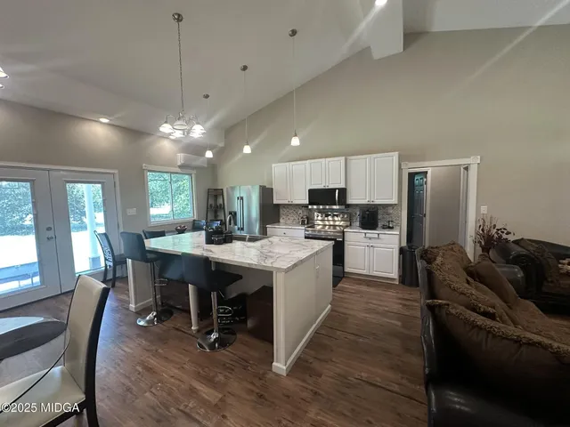 a kitchen with a table chairs refrigerator and microwave