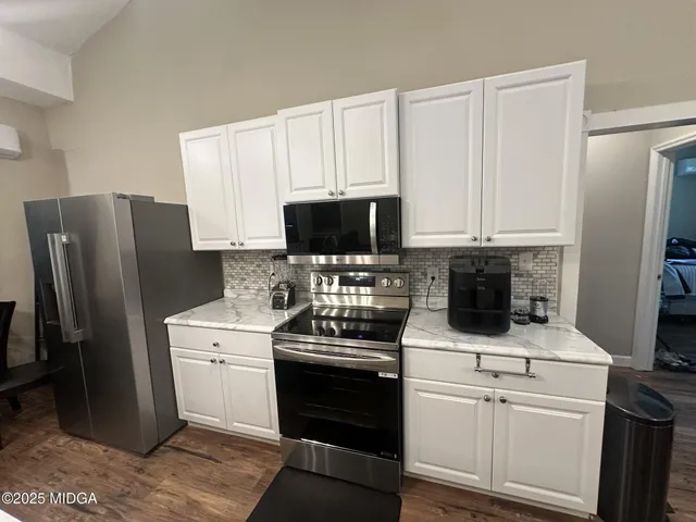 a kitchen with a refrigerator stove and microwave