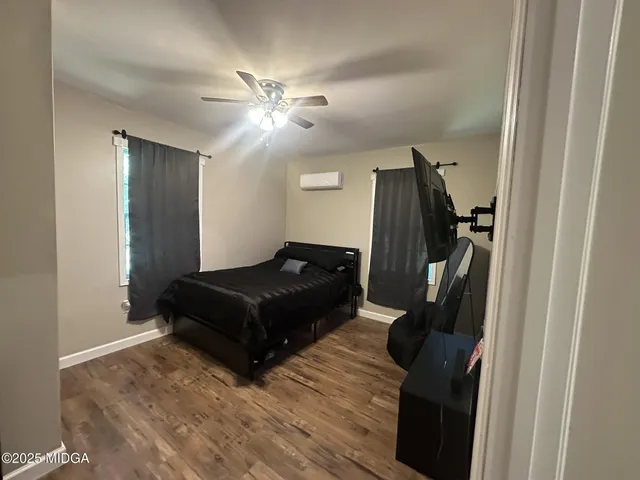 a bedroom with a bed and a mirror