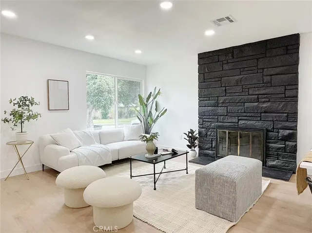 a living room with furniture a window and a fireplace