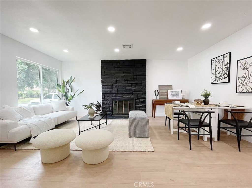a living room with fireplace furniture and a wooden floor