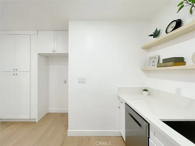 a room with a sink cabinets and utility