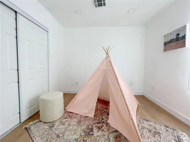 a living room with a couch and wooden floor