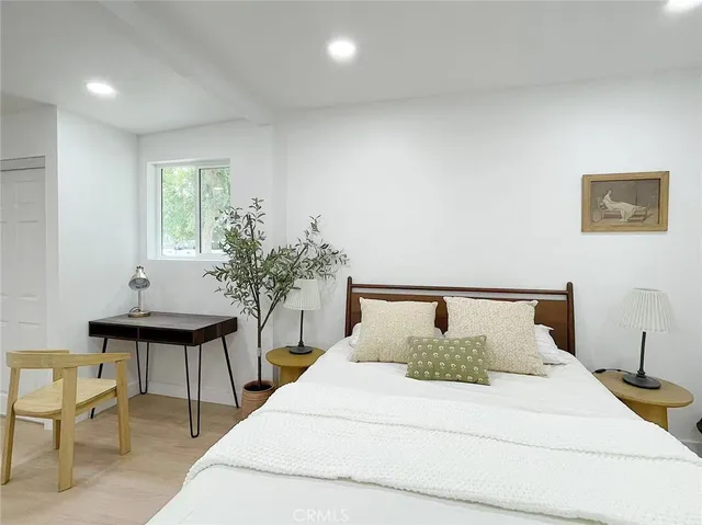 a bedroom with a bed and a table