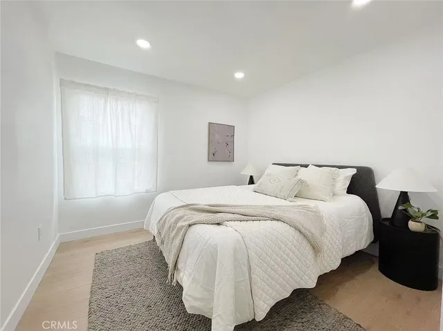 a bedroom with bed and window