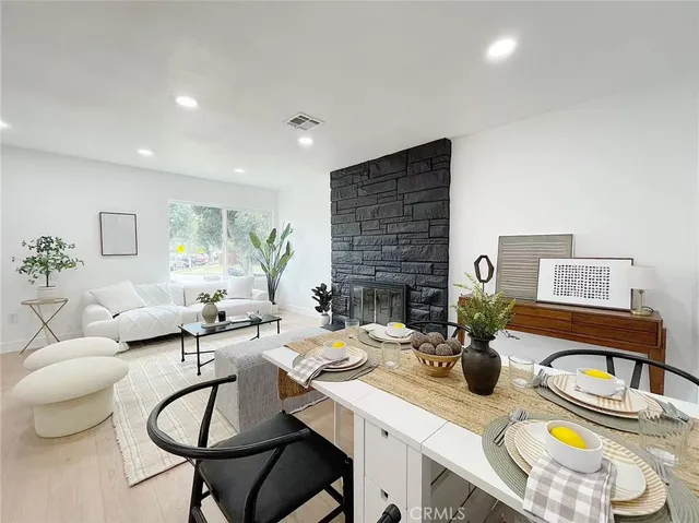 a living room with fireplace furniture and a table