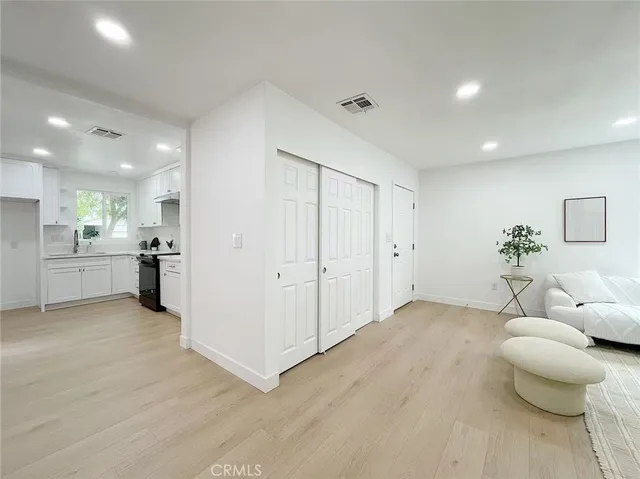 a view of a livingroom with furniture and an entryway