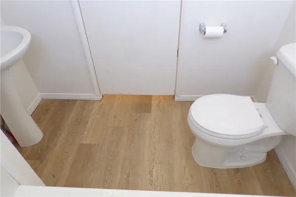 a white toilet sitting next to a sink