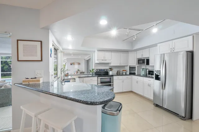 a bathroom with a sink a toilet and a window