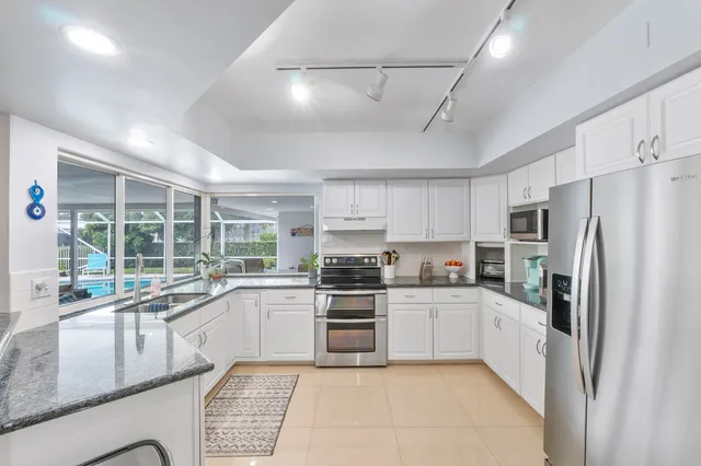 a spacious bedroom with a bed and a chandelier