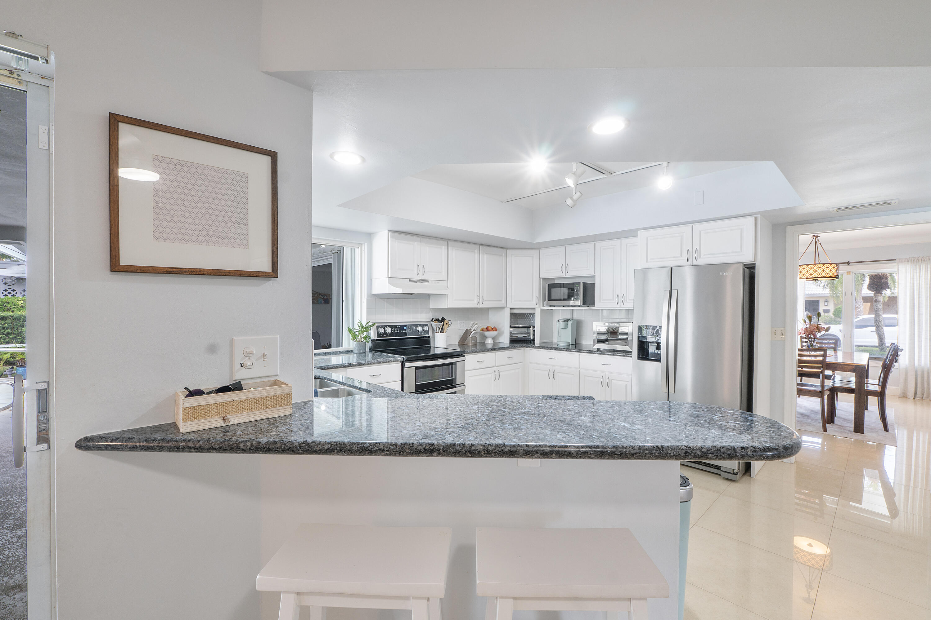 772 Apple Tree Lane Boca Raton, FL 33486 - Photo 14 of 39 a kitchen with granite countertop a center island and appliances