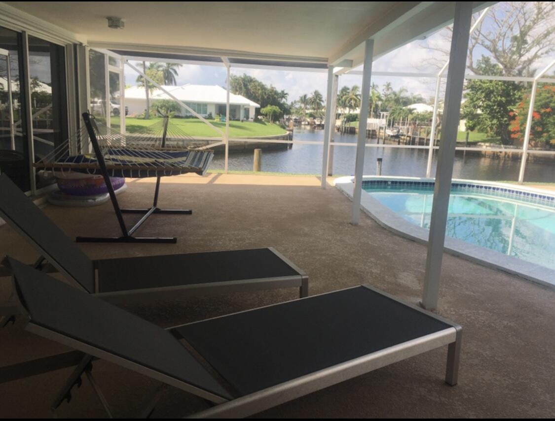 772 Apple Tree Lane Boca Raton, FL 33486 - Photo 31 of 39 a living room with a floor to ceiling window and an outdoor view