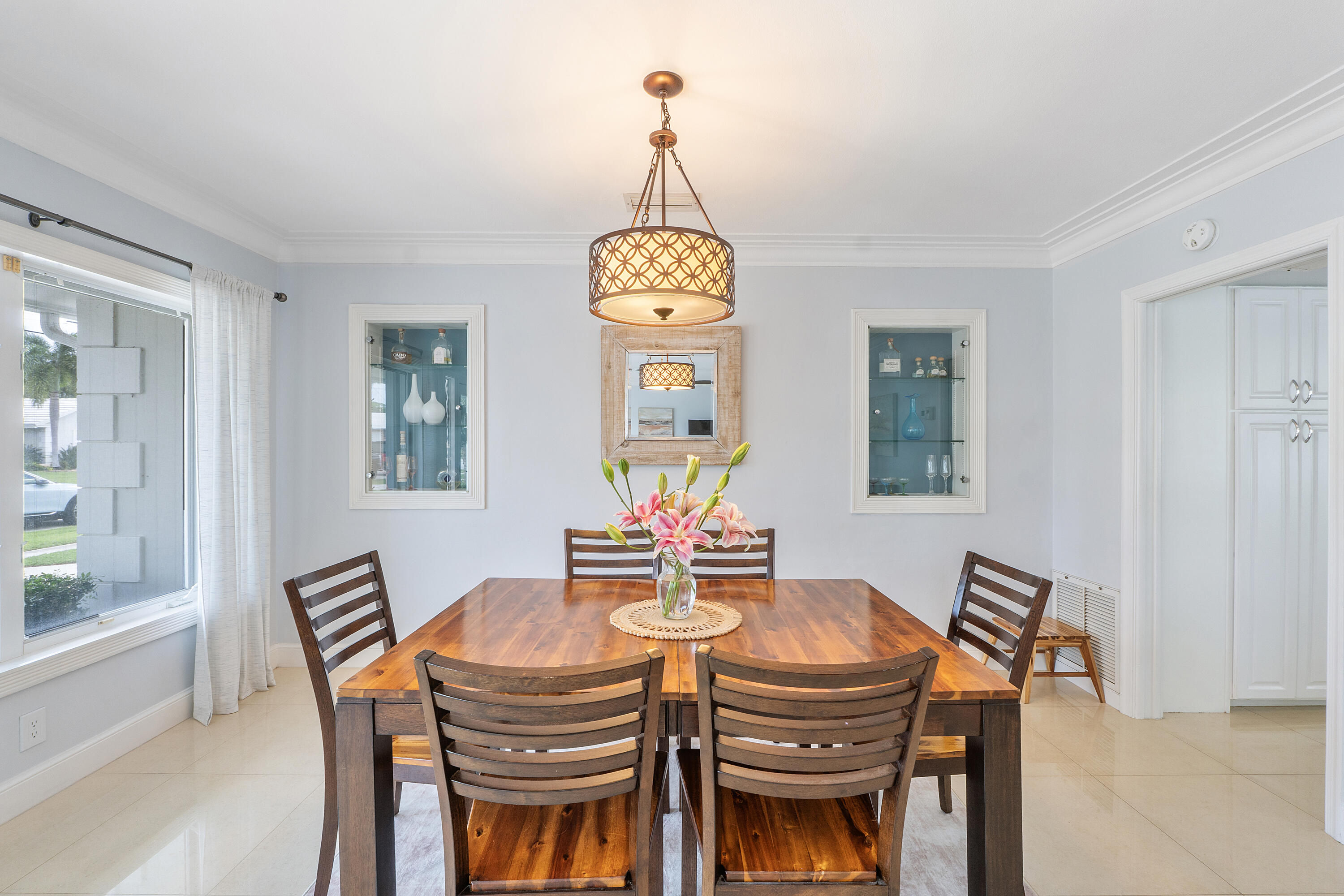 772 Apple Tree Lane Boca Raton, FL 33486 - Photo 10 of 39 a dining room with furniture a chandelier and wooden floor