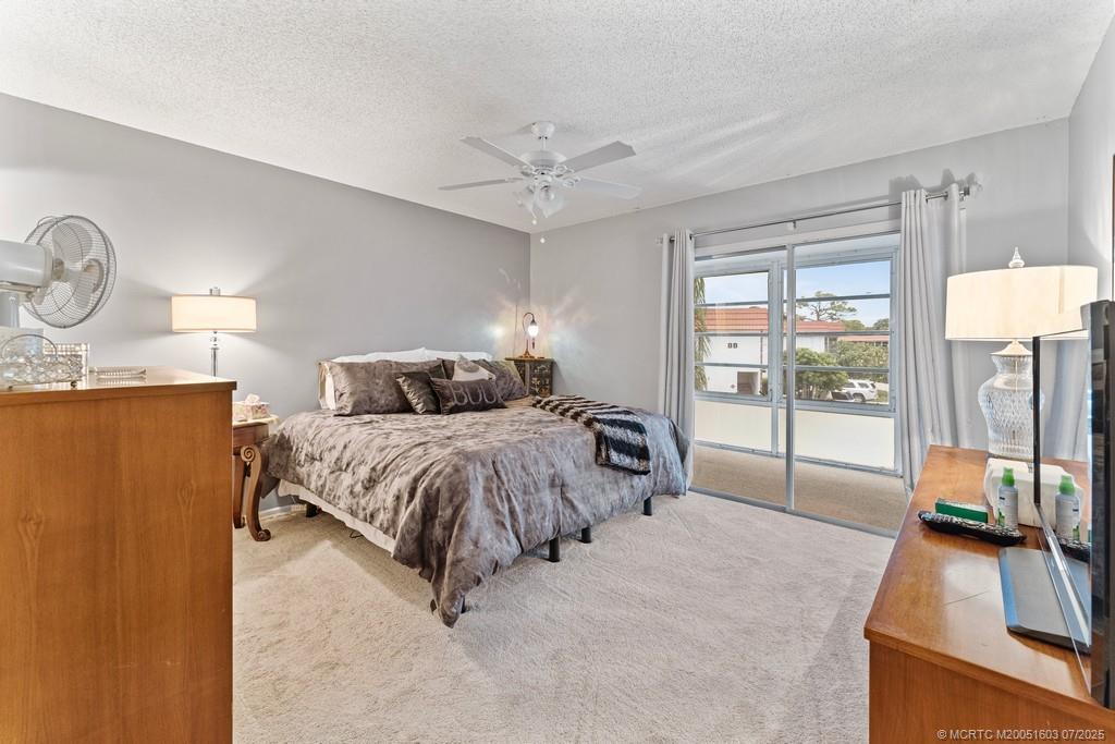 2600 Southeast Ocean Boulevard, Unit FF14 Stuart, FL 34996 - Photo 15 of 26 a spacious bedroom with a bed and a large window
