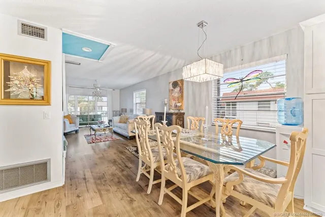 a view of a dining room with furniture wooden floor and a chandelier