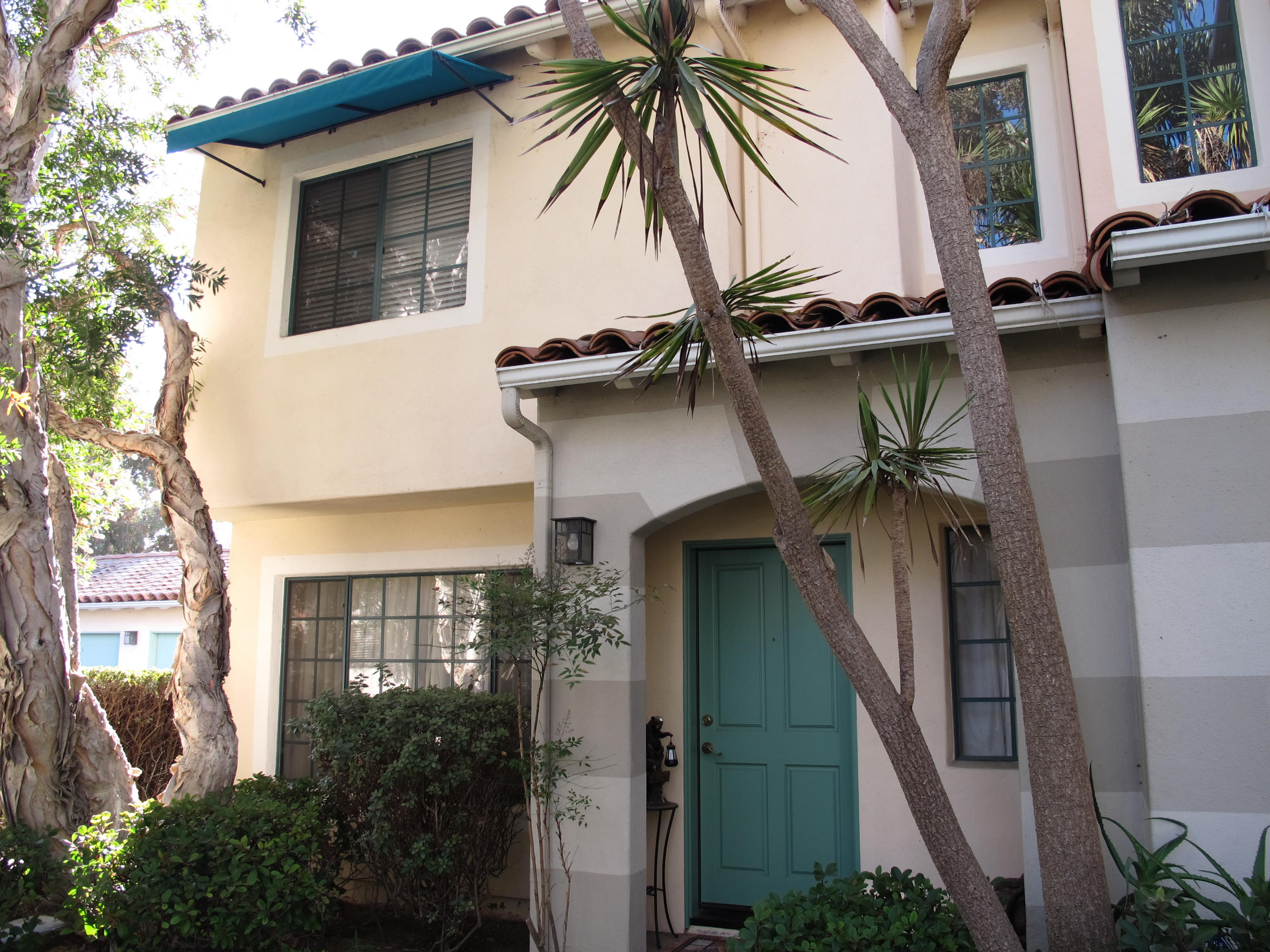 4297 Carpinteria Avenue, Unit 13 Carpinteria, CA 93013 - Photo 1 of 17 a house view with a garden space