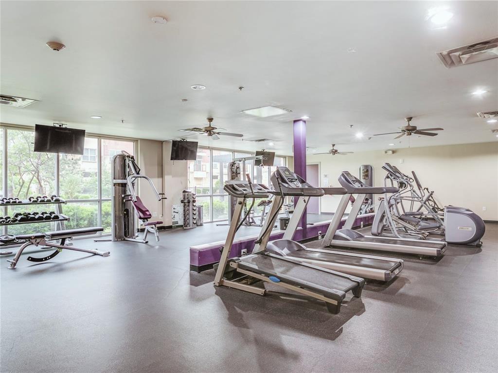 1100 West Trinity Mills Road, Unit 4042 Carrollton, TX 75006 - Photo 17 of 19 Exercise room featuring ceiling fan, a wall of windows, and recessed lighting