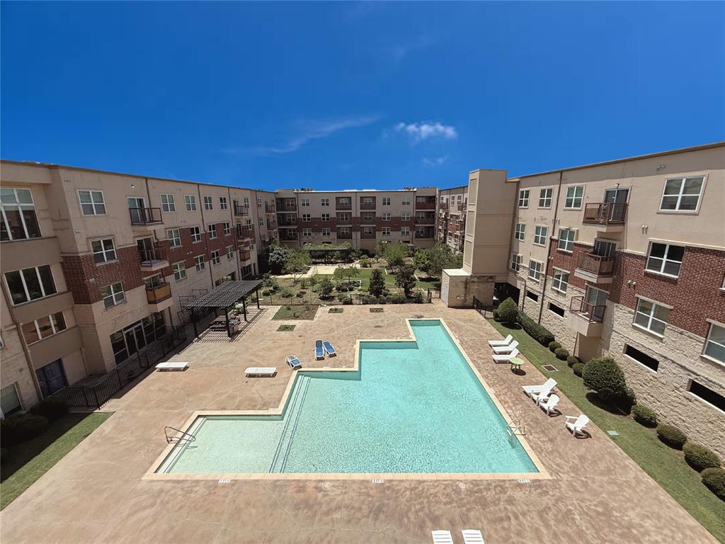 1100 West Trinity Mills Road, Unit 4042 Carrollton, TX 75006 - Photo 19 of 19 Overlooking the community pool with a patio area from the balcony