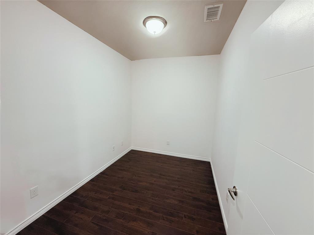 1100 West Trinity Mills Road, Unit 4042 Carrollton, TX 75006 - Photo 5 of 19 Study or office featuring dark wood-style flooring and baseboards