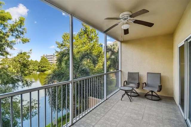 a kitchen with a refrigerator and white cabinets