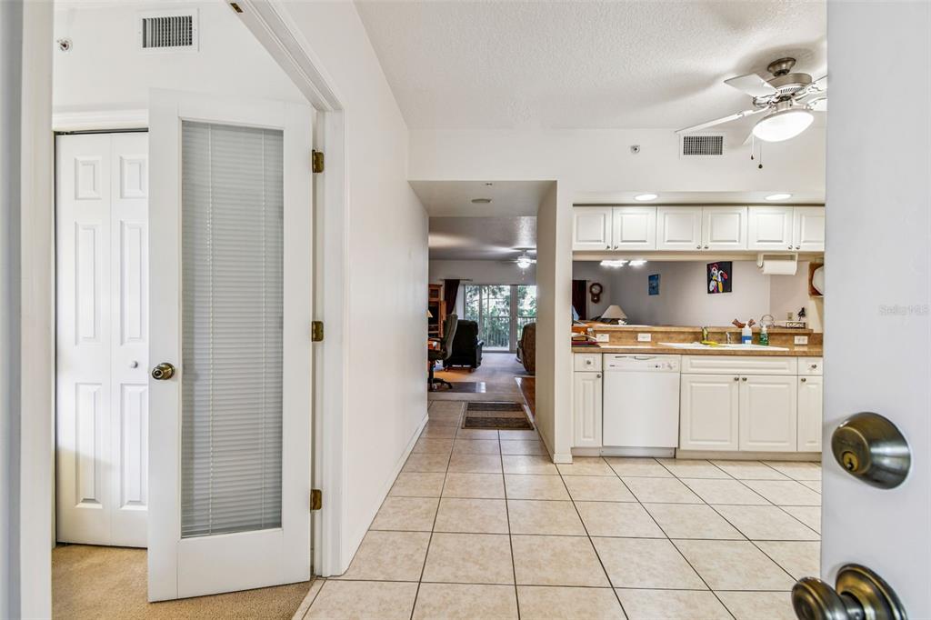 960 Starkey Road, Unit 2203 Largo, FL 33771 - Photo 19 of 53 a kitchen with a refrigerator and white cabinets