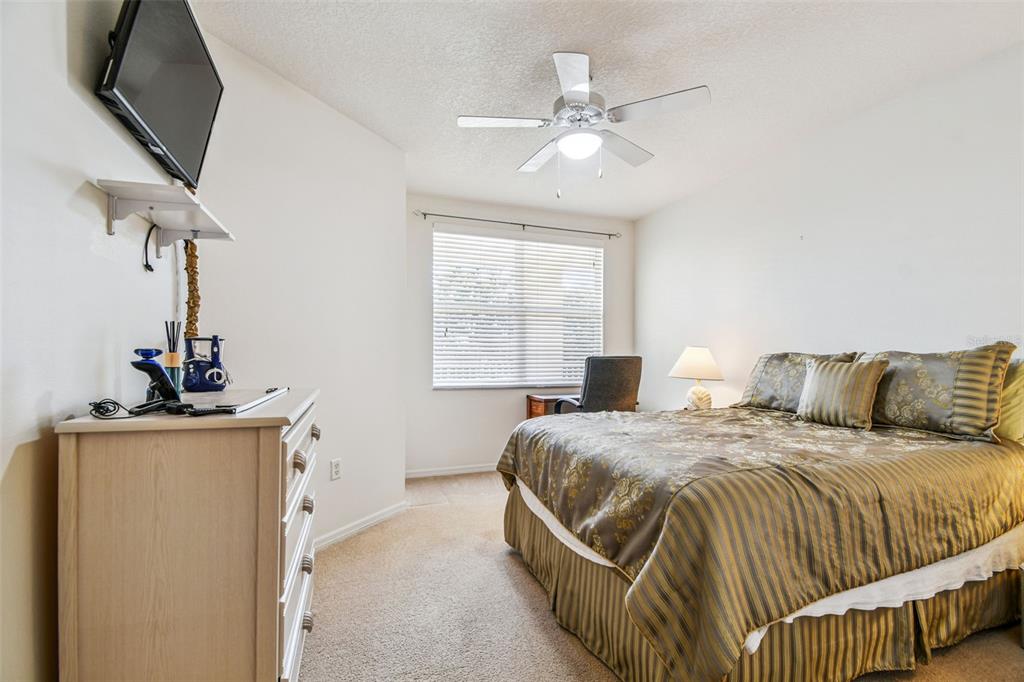 960 Starkey Road, Unit 2203 Largo, FL 33771 - Photo 23 of 53 a bedroom with a bed and a chandelier