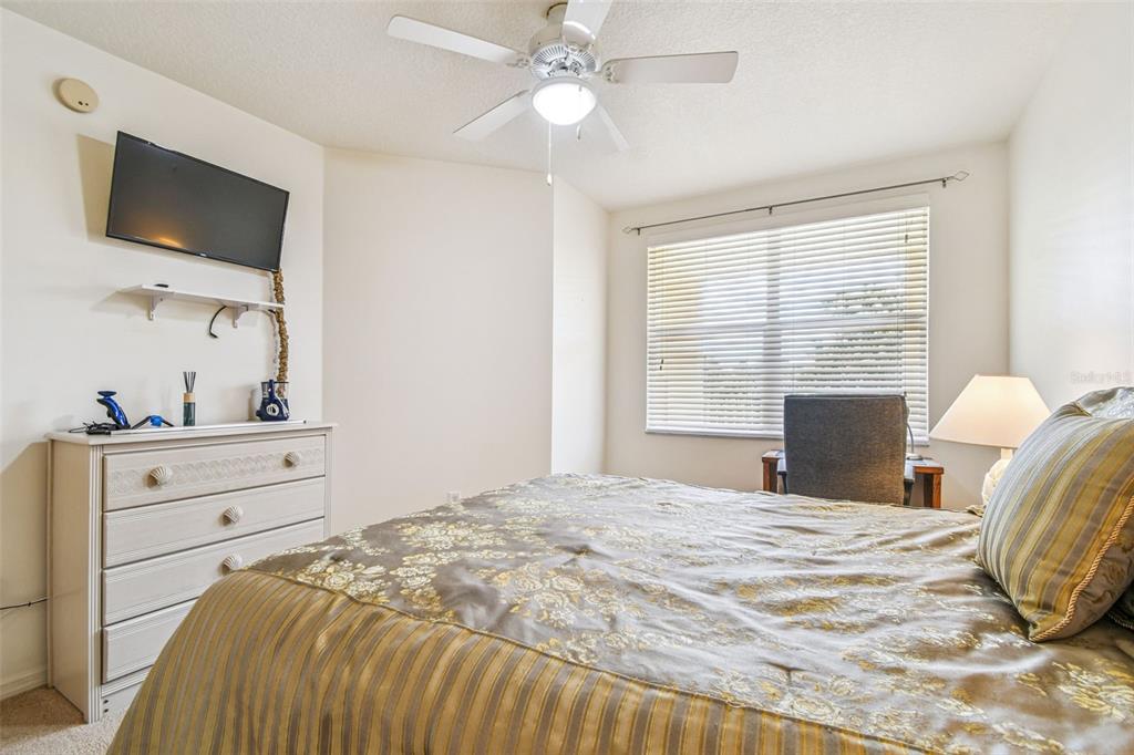 960 Starkey Road, Unit 2203 Largo, FL 33771 - Photo 26 of 53 a bedroom with a bed and a flat screen tv