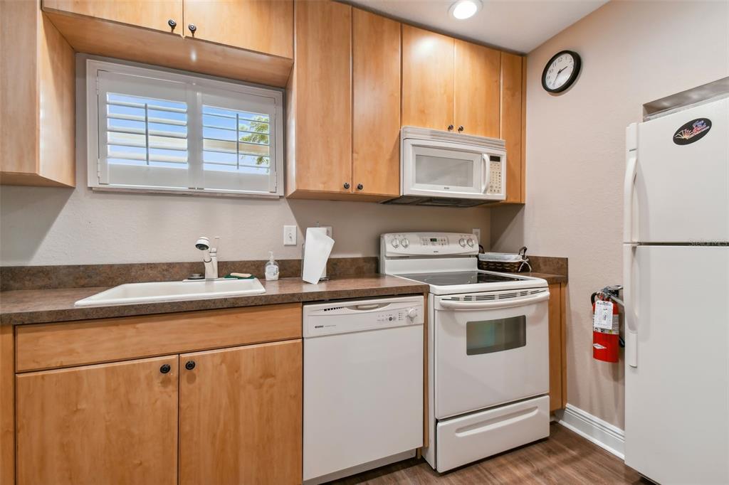 960 Starkey Road, Unit 2203 Largo, FL 33771 - Photo 36 of 53 a kitchen with stainless steel appliances granite countertop a sink a stove and a refrigerator