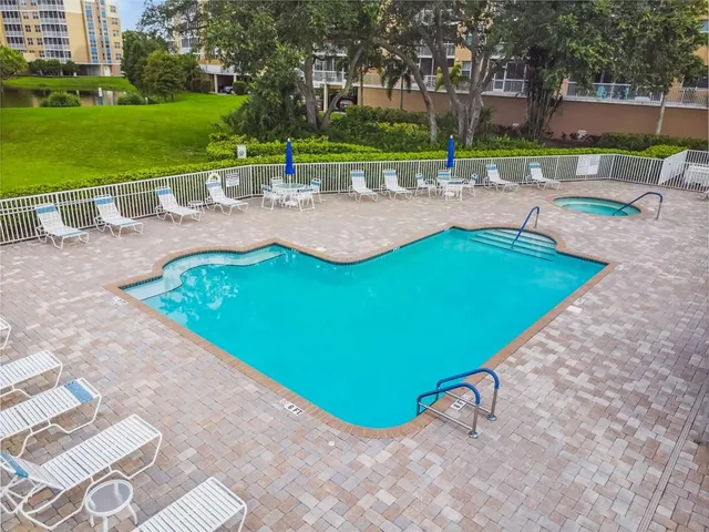 an aerial view of a house with swimming pool and patio